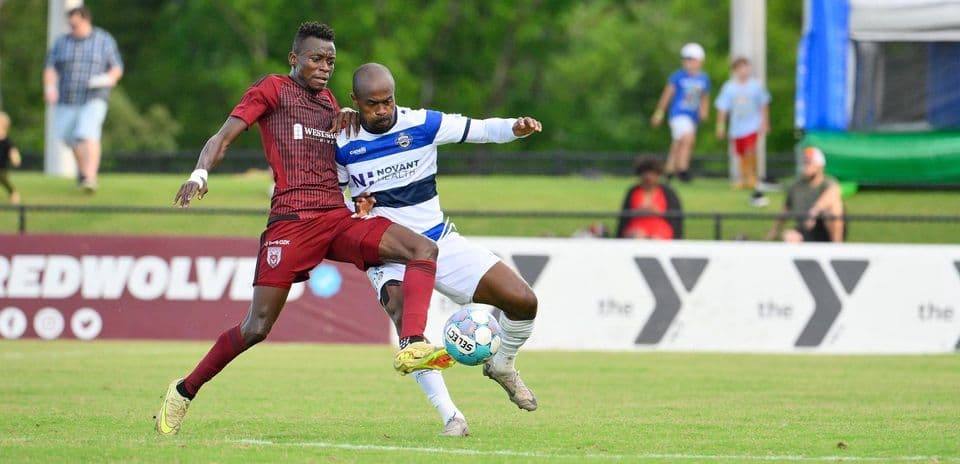 Players competing for the ball in USL match Players competing for the ball in USL match