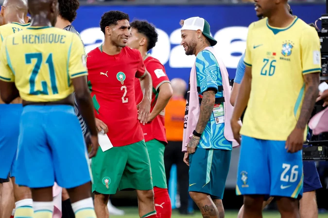 Players from Brazil and Morocco interacting on field Players from Brazil and Morocco interacting on field