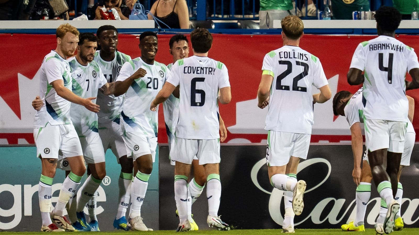 Players celebrating a goal on the field Players celebrating a goal on the field