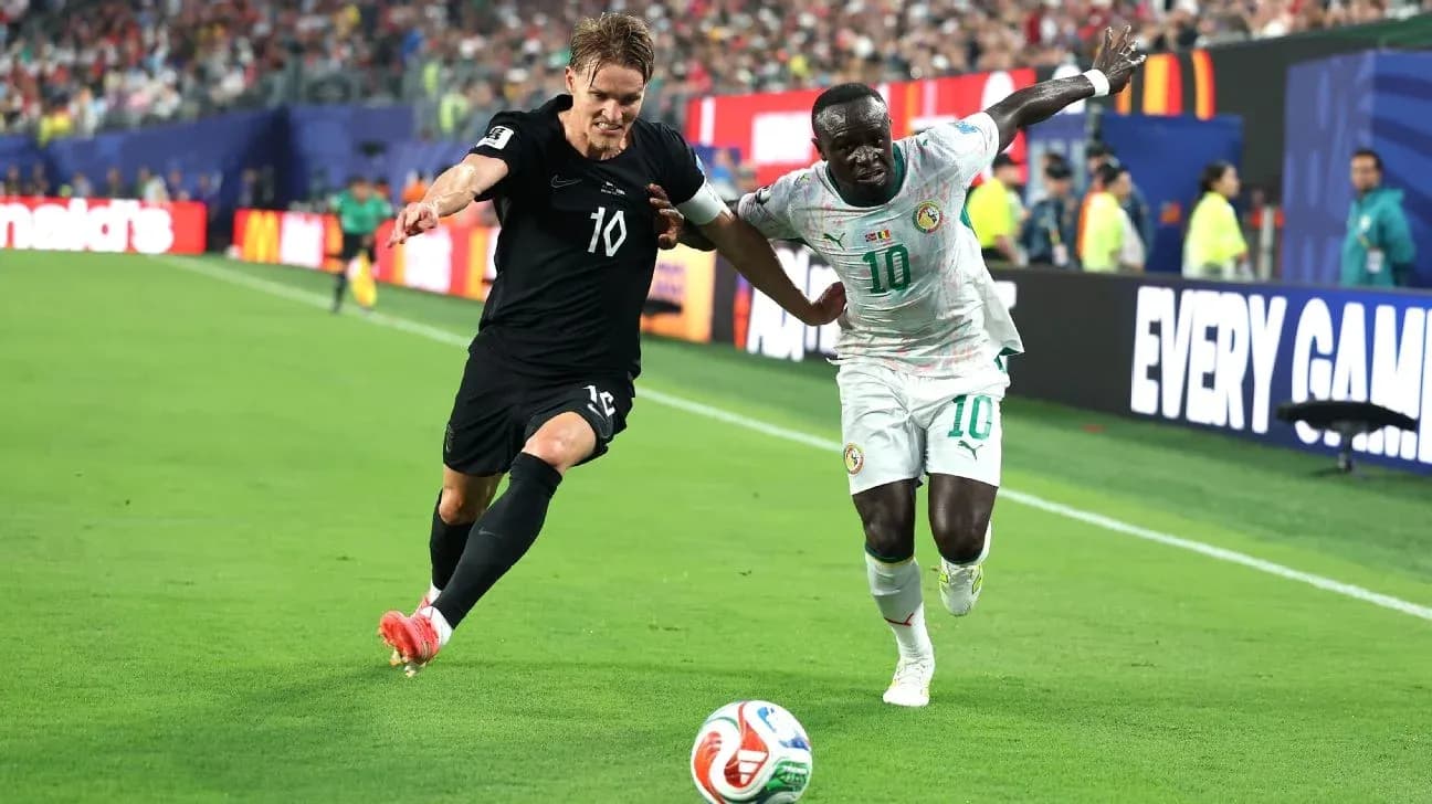 Two players competing for the ball in a match Two players competing for the ball in a match