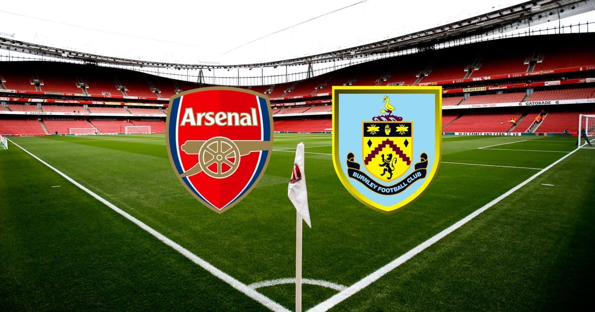 Arsenal and Burnley club logos on stadium pitch Arsenal and Burnley club logos on stadium pitch