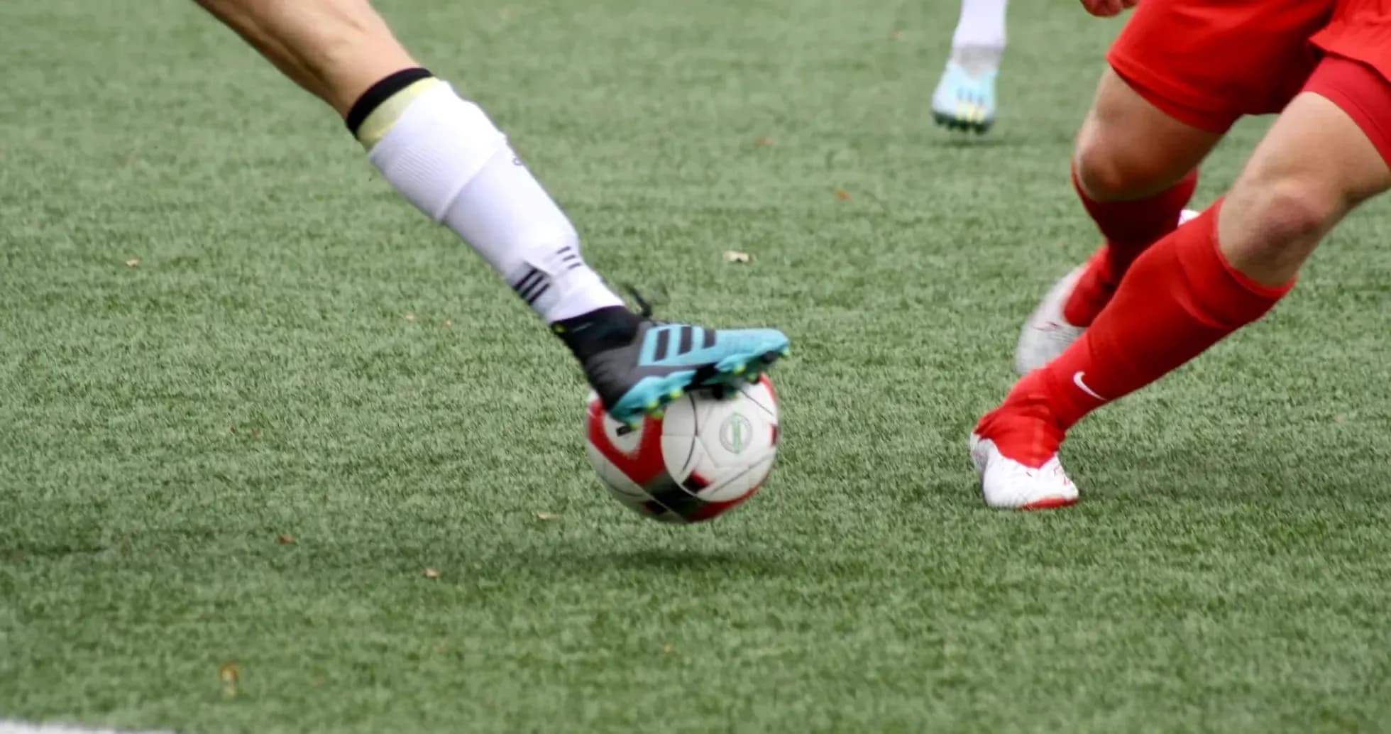 Players competing for the ball in football match Players competing for the ball in football match