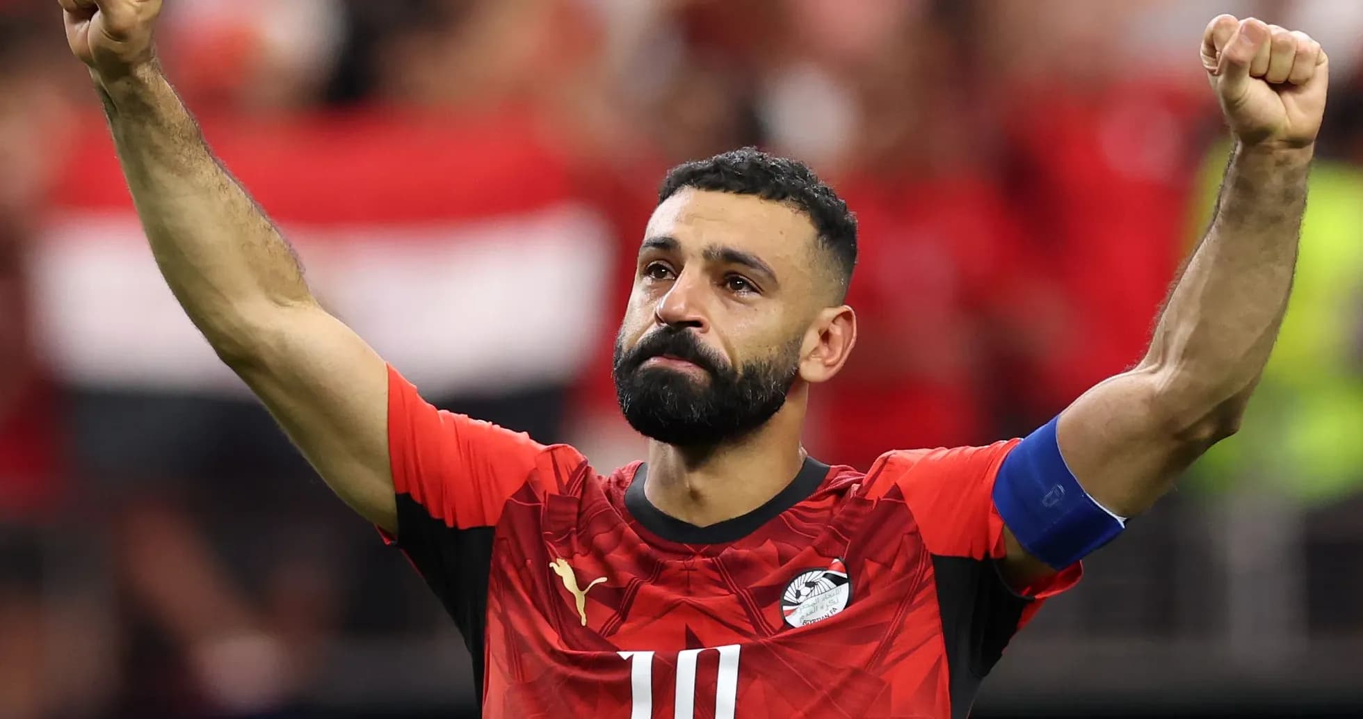 Player celebrating with raised fist in red jersey Player celebrating with raised fist in red jersey