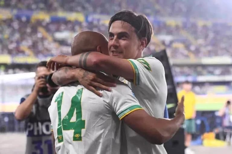 Players celebrating with an embrace after a match Players celebrating with an embrace after a match