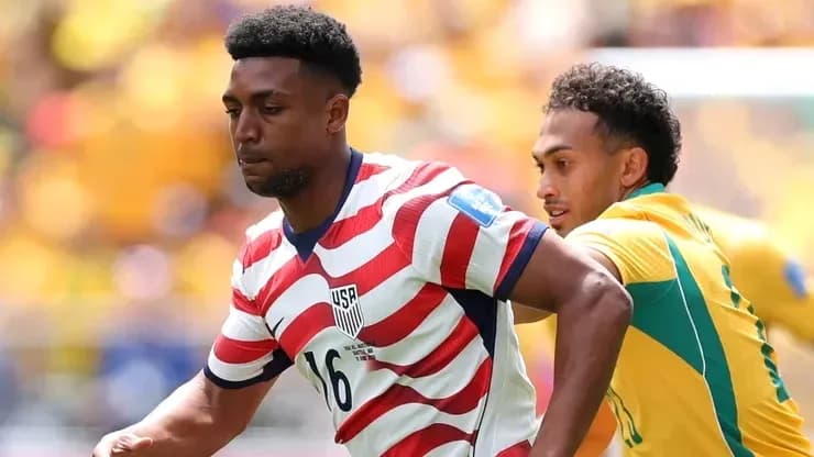 Player wearing USA jersey evading opponent during match Player wearing USA jersey evading opponent during match