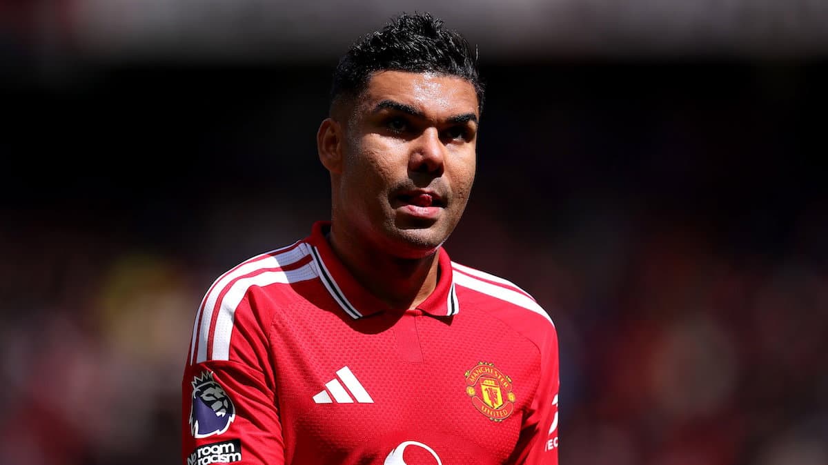 Player in red Manchester United jersey on field Player in red Manchester United jersey on field