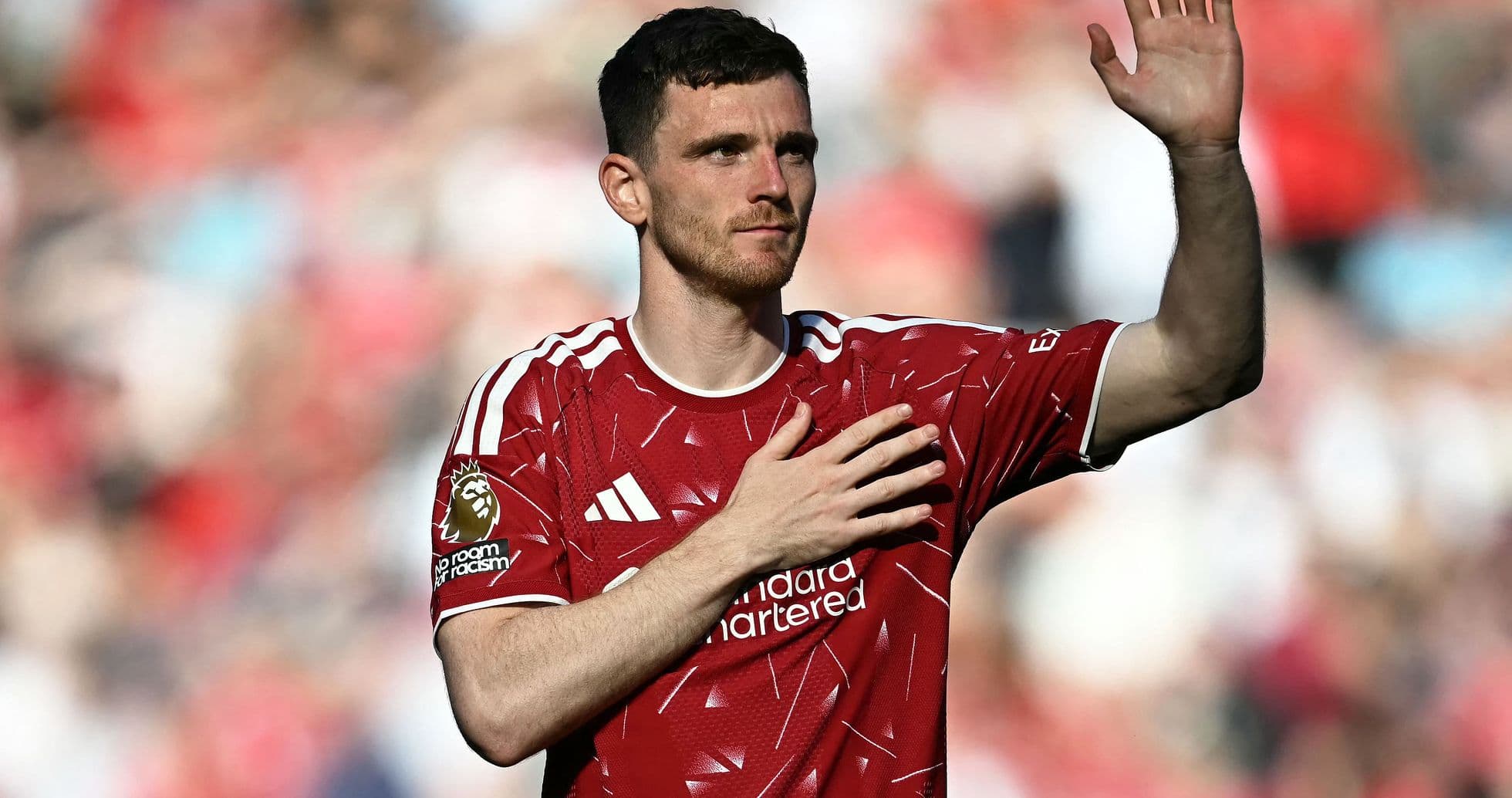 Player waving with hand on heart in red jersey Player waving with hand on heart in red jersey