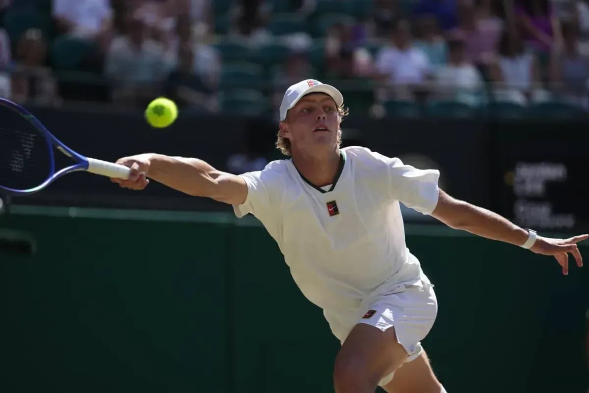 Player stretching to hit a tennis ball during match Player stretching to hit a tennis ball during match