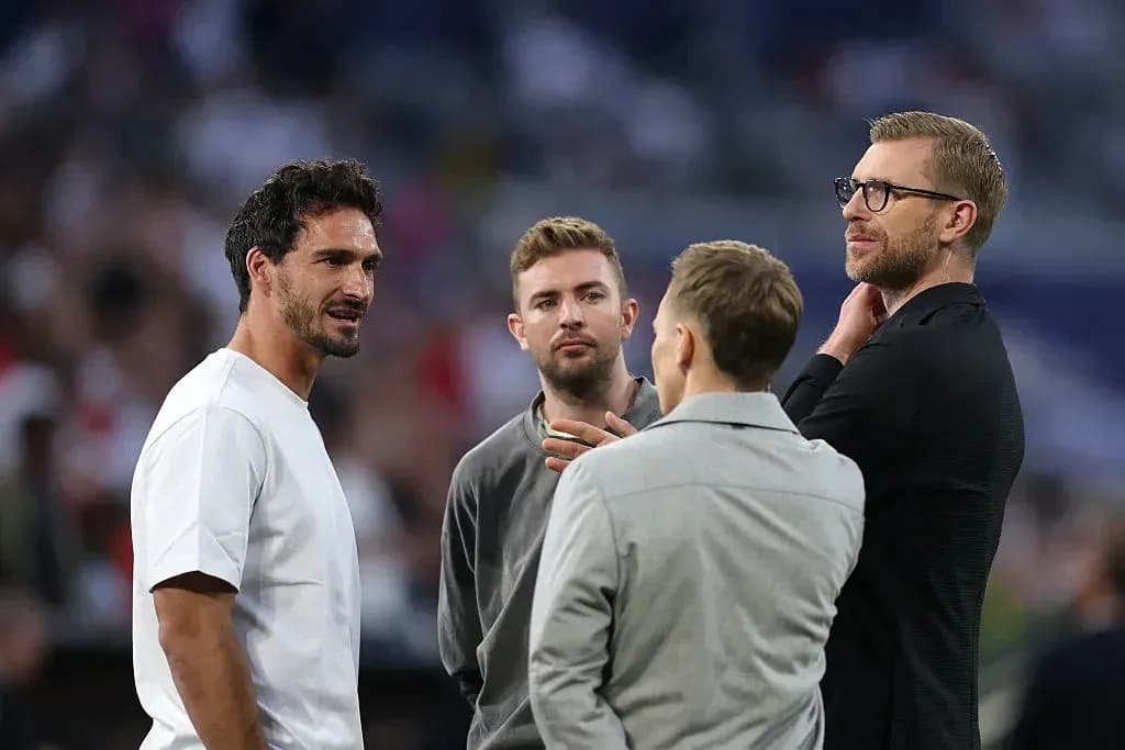 Four men discussing on the field before match Four men discussing on the field before match