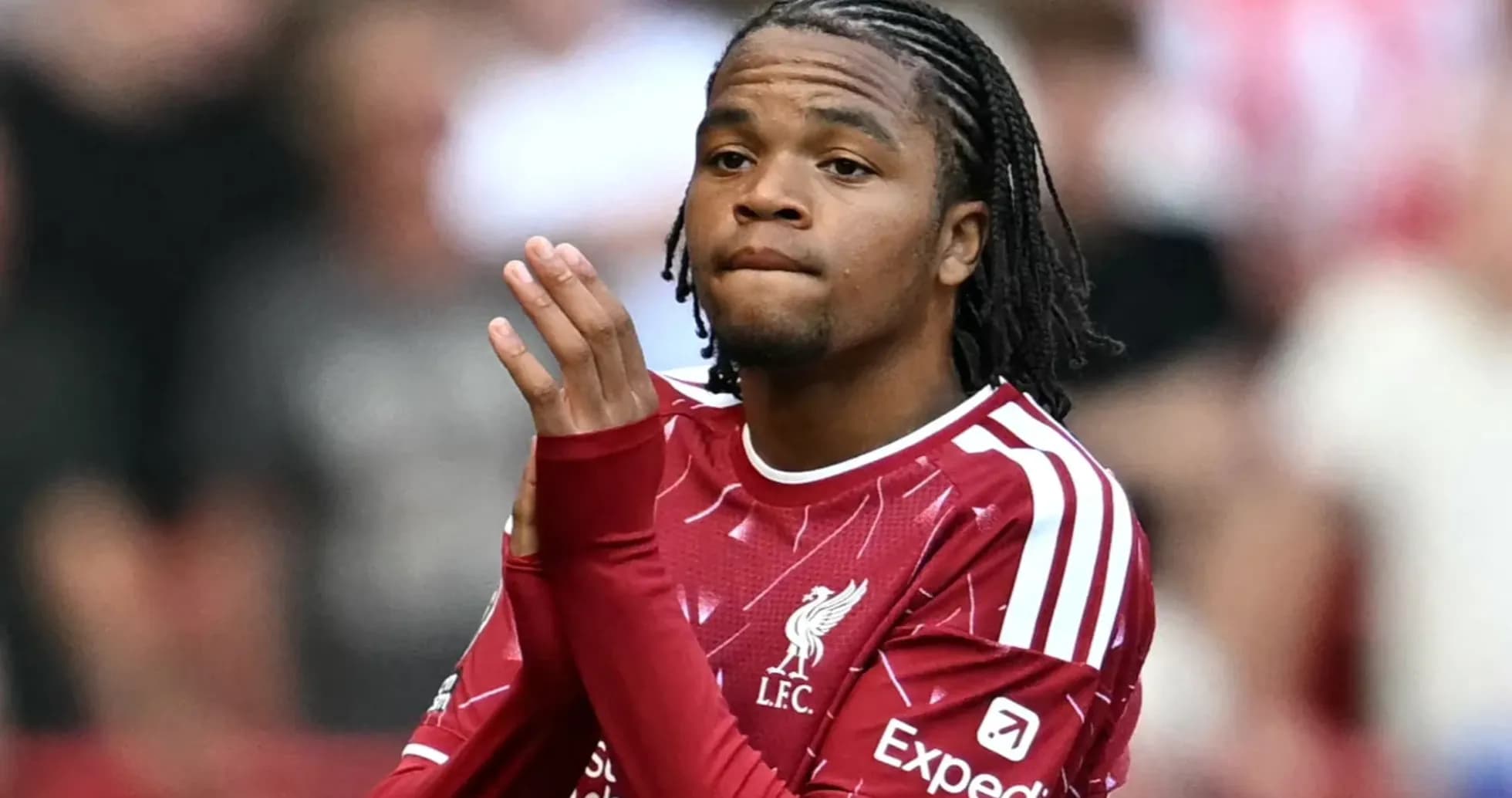 Player in Liverpool kit applauding fans during match Player in Liverpool kit applauding fans during match