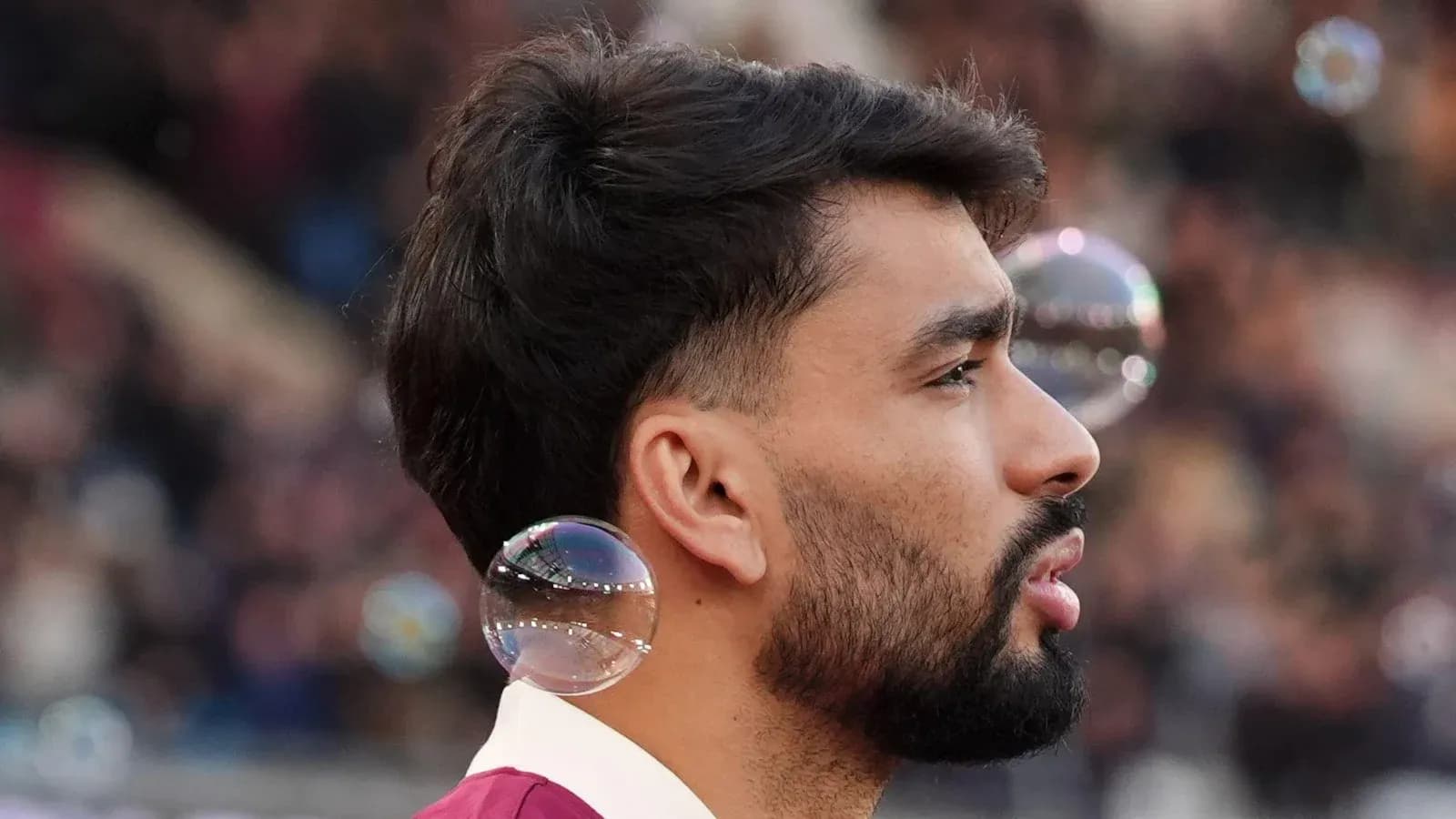 Player with bubbles near ear during match Player with bubbles near ear during match