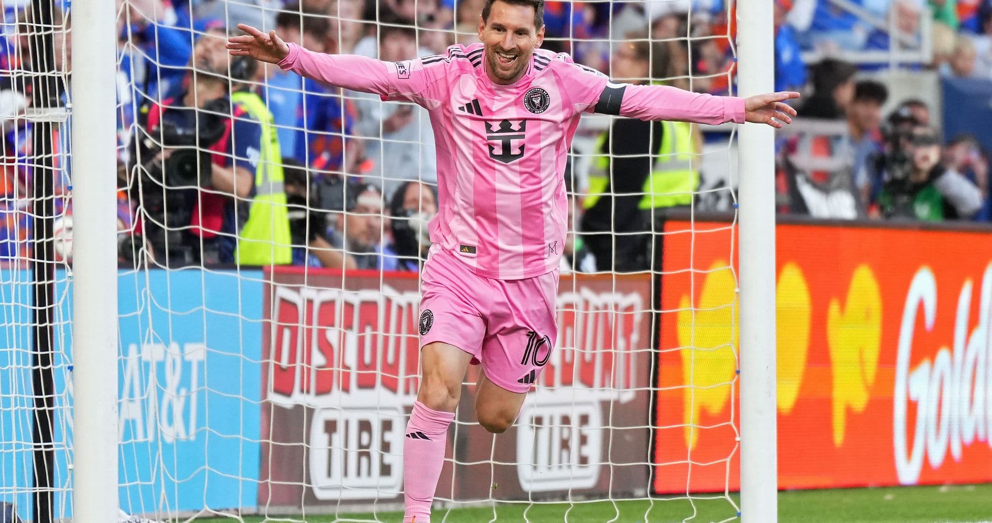 Player celebrating a goal in pink jersey Player celebrating a goal in pink jersey