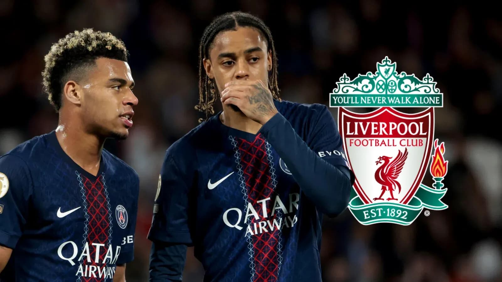 Two players discussing during match with Liverpool logo Two players discussing during match with Liverpool logo
