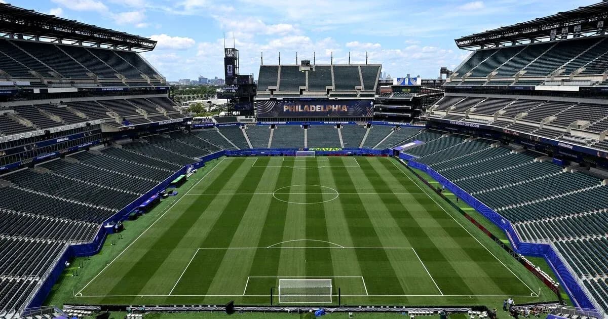 Empty soccer stadium with well-maintained field Empty soccer stadium with well-maintained field