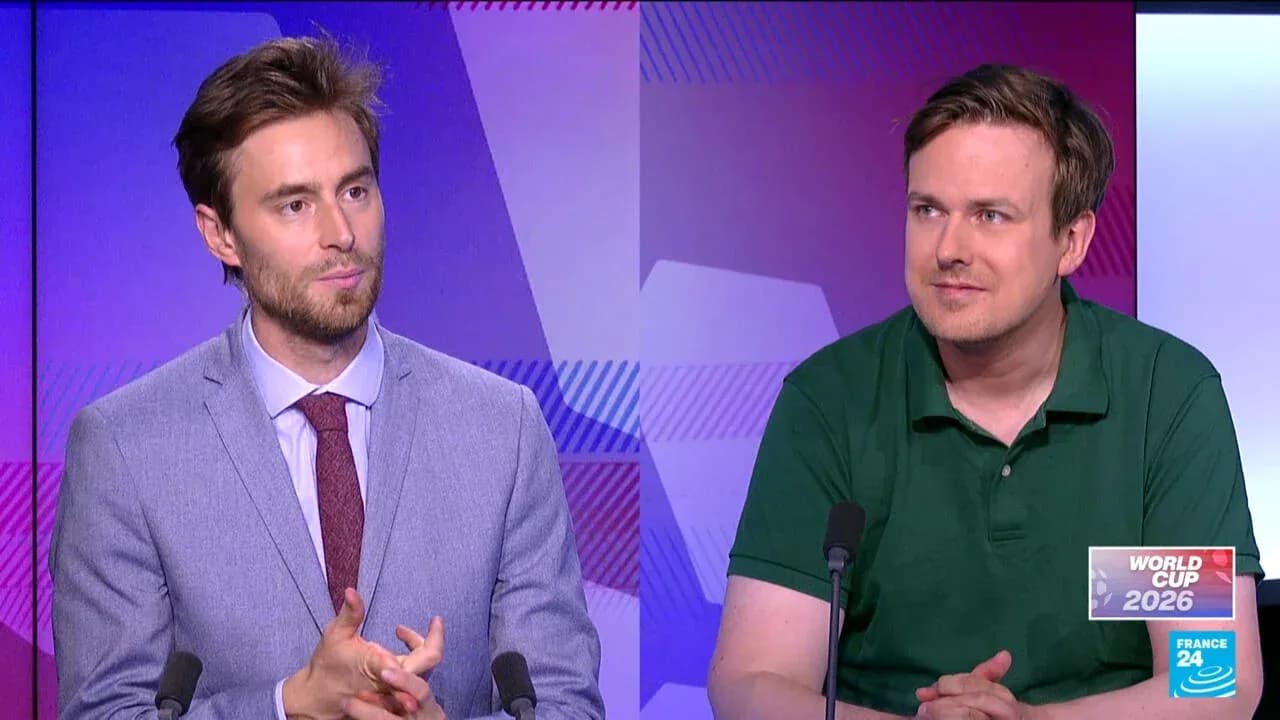 Two commentators discussing World Cup 2026 on set Two commentators discussing World Cup 2026 on set